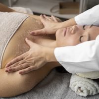 high-angle-woman-getting-massaged-spa
